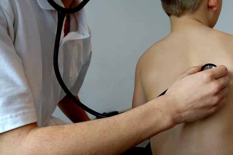 doctor checking a child's heartbeat with stethescope