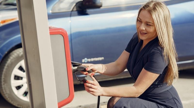 business woman charging EV